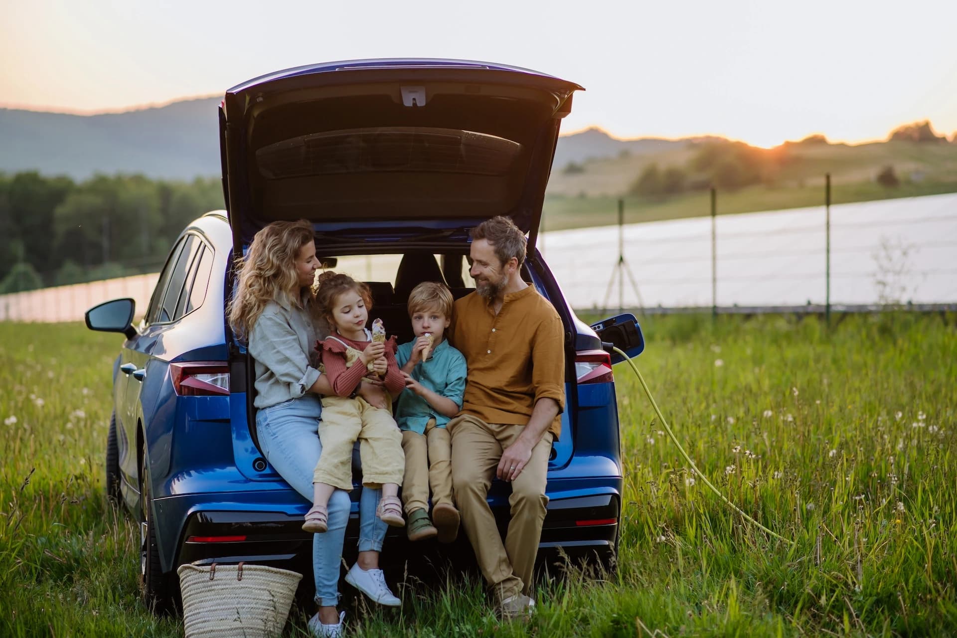 Happy family with baby taking a roadside break during a road trip