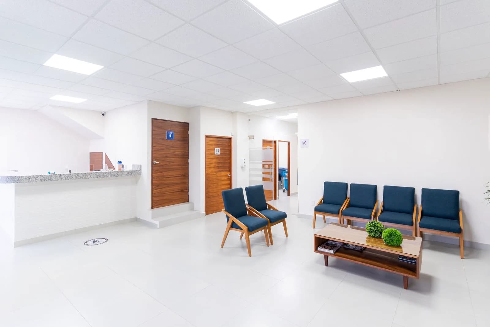 Clean and bright pediatric clinic waiting room with modern seating and a calm professional atmosphere