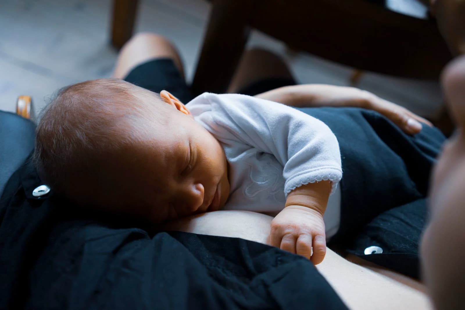 Baby sleeping peacefully on a parent's chest