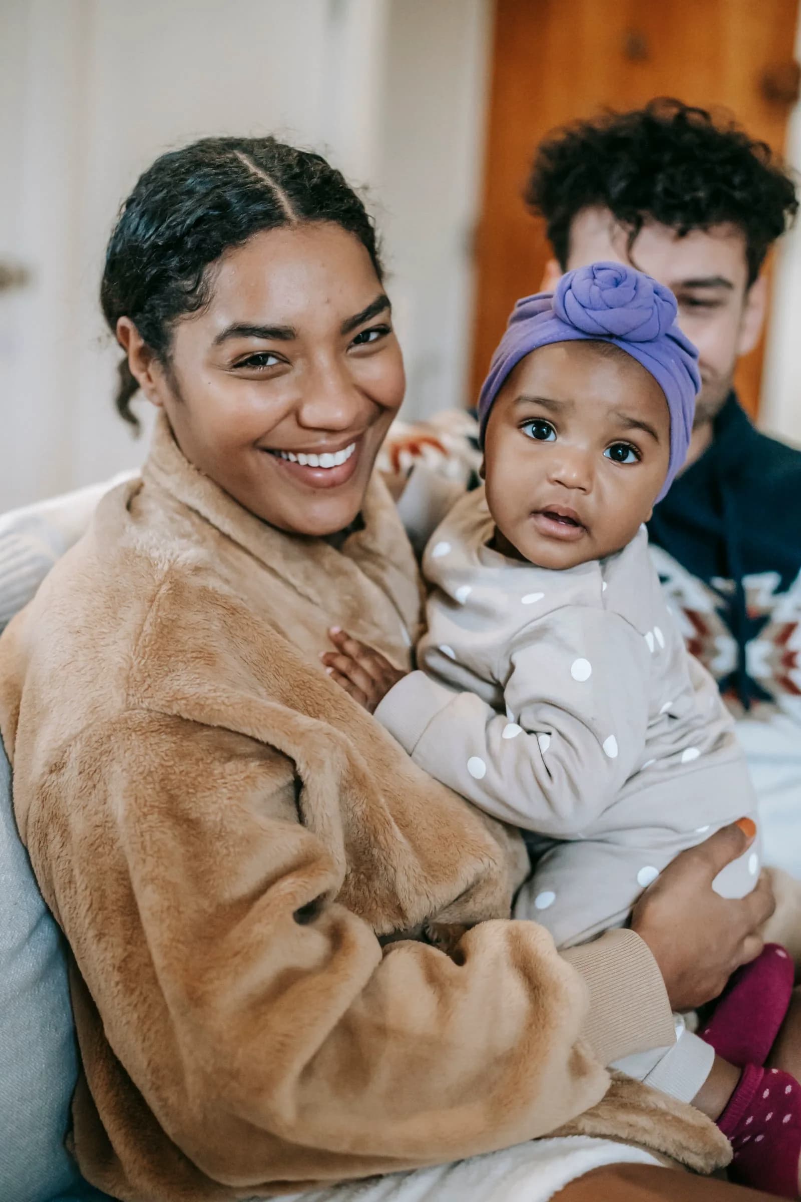 Happy mother holding her baby indoors, sharing a joyful moment after a successful pediatrician appointment