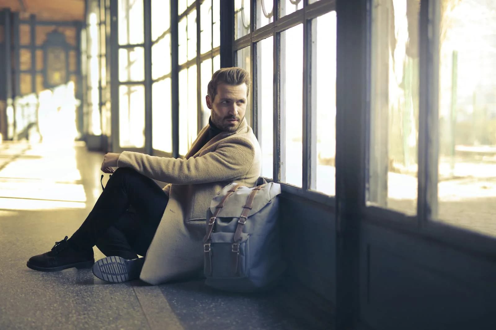 Birth partner sitting with backpack in waiting area during long hospital stay