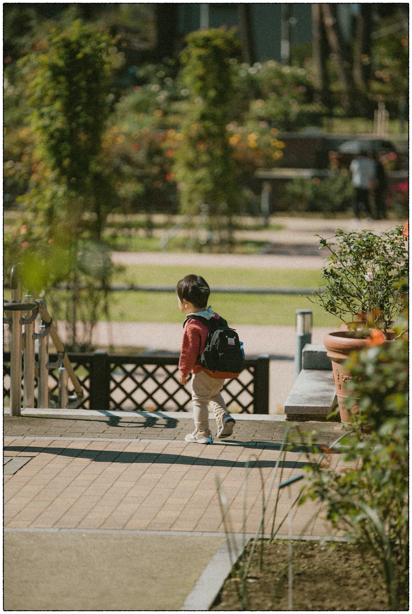 Child with backpack walking through park, realistic daycare morning routine