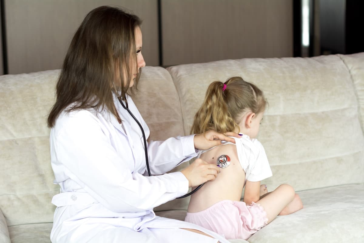 Doctor examining a sick toddler at a pediatric clinic appointment