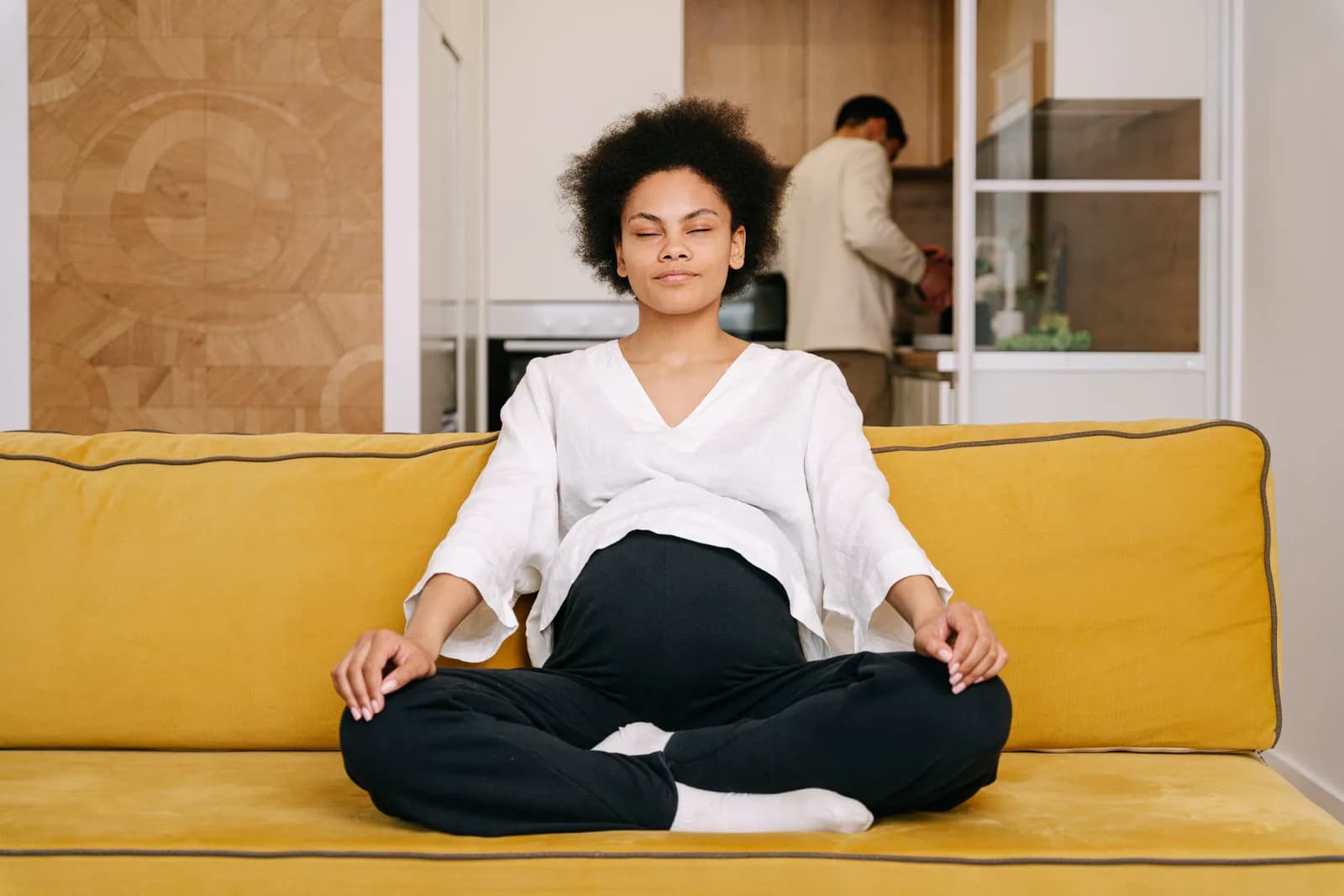 Pregnant woman relaxing at home during third trimester, preparing mentally for labor and delivery